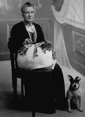 Mary Ann Walker with lace pillow and dog